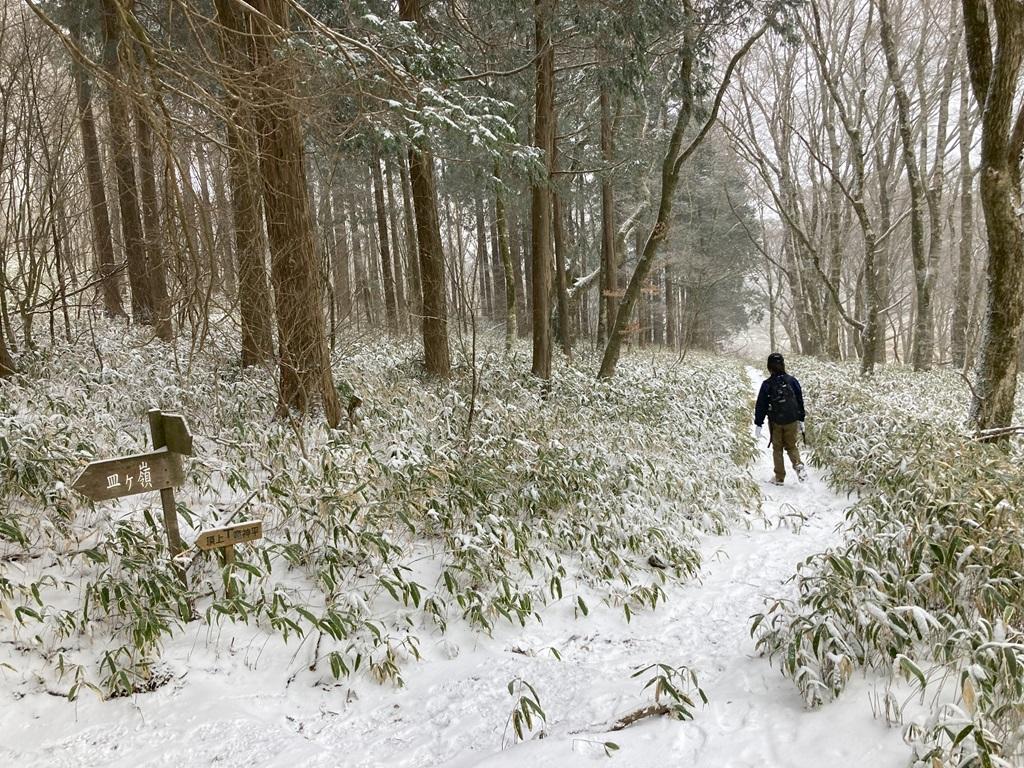 雪の山道を歩く娘